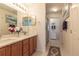 Bright main bathroom with double vanity, neutral tile, and walk-in shower at 1768 Sw 156Th Ln, Ocala, FL 34473