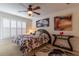 Relaxing main bedroom with ceiling fan, shuttered windows, and decorative art at 1768 Sw 156Th Ln, Ocala, FL 34473