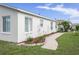 Home exterior featuring meticulous landscaping and a winding sidewalk at 1768 Sw 156Th Ln, Ocala, FL 34473