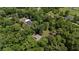 Aerial view of a house surrounded by dense trees, emphasizing its secluded location at 19130 Nw 60Th Ave, Reddick, FL 32686