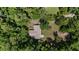 Aerial view of a home nestled among mature trees, showcasing its private setting at 19130 Nw 60Th Ave, Reddick, FL 32686