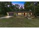 Charming single-story home featuring a well-manicured lawn, neutral paint, and a two-car garage at 19130 Nw 60Th Ave, Reddick, FL 32686