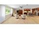 Bright and airy living space with wood-look tile floors, with an open view to the kitchen at 19130 Nw 60Th Ave, Reddick, FL 32686