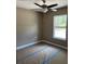 A bedroom featuring a ceiling fan and a window, complete with pristine white trim at 19622 Sw Marine Blvd, Dunnellon, FL 34431