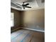 Inviting bedroom featuring a tray ceiling, fan, and ample space to relax at 19622 Sw Marine Blvd, Dunnellon, FL 34431