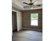 Comfortable bedroom features natural light from a window and a ceiling fan at 19622 Sw Marine Blvd, Dunnellon, FL 34431