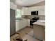 Modern kitchen features stainless steel appliances, white cabinetry, and granite countertops at 19622 Sw Marine Blvd, Dunnellon, FL 34431