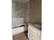 Bathroom featuring tub with marble tile, granite countertop and white cabinets at 20769 Sw Oriole Dr, Dunnellon, FL 34431
