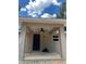 Covered entrance featuring a ceiling fan, black front door, and window at 20769 Sw Oriole Dr, Dunnellon, FL 34431