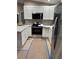Well-lit kitchen featuring stainless steel appliances, white cabinets, and granite countertops at 20769 Sw Oriole Dr, Dunnellon, FL 34431