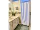 Traditional bathroom featuring vanity with storage, tiled floors, and shower with tub at 2305 Ne 40Th Ave, Ocala, FL 34470