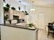 Cozy kitchen featuring neutral cabinets, modern appliances, and eat-in bar at 2305 Ne 40Th Ave, Ocala, FL 34470