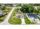 Aerial view of a single-Gathering home featuring a long driveway, fenced yard and green lawn at 28 Hemlock Radial Loop, Ocala, FL 34472