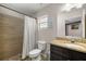 Bathroom includes a tiled shower, toilet, window, and granite countertop vanity with mirror at 28 Hemlock Radial Loop, Ocala, FL 34472