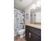 Bathroom features a vanity with a granite countertop and a shower with shark curtain at 28 Hemlock Radial Loop, Ocala, FL 34472
