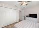 Well-lit bedroom with ceiling fan, closet and television over a white dresser at 28 Hemlock Radial Loop, Ocala, FL 34472