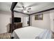 This is the main bedroom with a four-poster bed, ceiling fan, television and closet at 28 Hemlock Radial Loop, Ocala, FL 34472