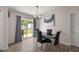Modern dining room with a sleek black table, leather chairs, and sliding glass doors at 28 Hemlock Radial Loop, Ocala, FL 34472