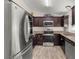 Updated kitchen featuring stainless steel appliances, dark cabinetry, and modern countertops at 28 Hemlock Radial Loop, Ocala, FL 34472