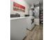 Laundry room features a washer and dryer with tiled floors, and an ornate painting on the wall at 28 Hemlock Radial Loop, Ocala, FL 34472