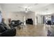 Spacious living room with wood-look tile flooring and a comfortable leather sofa set at 28 Hemlock Radial Loop, Ocala, FL 34472