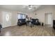 Bright living room featuring wood-look tile floors, two sofas, and a glass coffee table at 28 Hemlock Radial Loop, Ocala, FL 34472