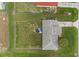 Aerial view of backyard with grass and privacy fence showcasing the roof and driveway at 316 Oak Track Dr, Ocala, FL 34472