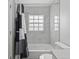 Bathroom with marble-look tiled shower/tub and coordinating vanity at 316 Oak Track Dr, Ocala, FL 34472