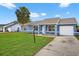Charming blue single Gathering home, featuring a well manicured lawn and driveway at 316 Oak Track Dr, Ocala, FL 34472