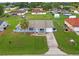 Charming single-story home featuring a well-manicured lawn, attached garage, and welcoming light blue painted facade at 316 Oak Track Dr, Ocala, FL 34472