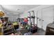 Garage full of items with pull-up bar, boxes, various tools, and an open garage door at 316 Oak Track Dr, Ocala, FL 34472