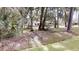 Exterior view of the rear of the home amongst mature trees in the backyard at 4121 Sw 6Th Ave, Ocala, FL 34471