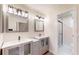 The bathroom has double sinks, modern lighting, and a glass door shower at 4121 Sw 6Th Ave, Ocala, FL 34471