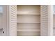 Bright closet with white louvered doors located in a room with light hardwood floors at 4121 Sw 6Th Ave, Ocala, FL 34471