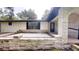 View of the home's exterior featuring stone accents, fresh paint, a small porch and black trim at 4121 Sw 6Th Ave, Ocala, FL 34471