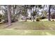 View of home with mature trees that offer plenty of shade, a well-manicured lawn, and charming curb appeal at 4121 Sw 6Th Ave, Ocala, FL 34471