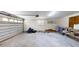 Open garage interior featuring a garage door, shelving, and concrete floor at 4121 Sw 6Th Ave, Ocala, FL 34471