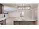 Open kitchen with island, fireplace and stainless steel appliances at 4121 Sw 6Th Ave, Ocala, FL 34471