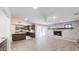 Features a brick fireplace, ceiling fan, stained-glass accents, and view into a stylishly updated kitchen at 4121 Sw 6Th Ave, Ocala, FL 34471