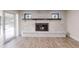 Living room features a white brick fireplace with mantle and hearth and wood look flooring at 4121 Sw 6Th Ave, Ocala, FL 34471
