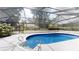 Screened-in pool with jacuzzi, surrounded by concrete patio and lush greenery at 4121 Sw 6Th Ave, Ocala, FL 34471