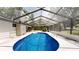 Enclosed pool area features a clean patio, with access to home and well-maintained pool for relaxation and fun at 4121 Sw 6Th Ave, Ocala, FL 34471