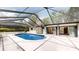 Serene screened-in pool featuring ample deck space and a lush backyard view, ideal for relaxation and outdoor entertaining at 4121 Sw 6Th Ave, Ocala, FL 34471