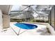 Inviting in-ground pool within a screened enclosure, complete with a spacious deck and serene outdoor ambiance at 4121 Sw 6Th Ave, Ocala, FL 34471