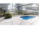 Enclosed pool area with pristine concrete, and ladder, offering a refreshing retreat at 4121 Sw 6Th Ave, Ocala, FL 34471