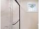 Walk-in shower with marble-style tiling and a decorative stained glass window at 4121 Sw 6Th Ave, Ocala, FL 34471