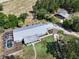 Aerial view of property showcasing the houses, pool, metal roofs, and green surroundings at 4501 Detour Rd, Haines City, FL 33844