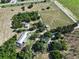 Expansive aerial view of the property featuring the home, outbuildings, and surrounding acreage at 4501 Detour Rd, Haines City, FL 33844