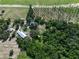 Aerial view of the property featuring lush greenery, outbuildings, and a beautiful main house at 4501 Detour Rd, Haines City, FL 33844