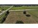 Aerial view of a large green grassy field and adjacent road under a partly cloudy sky at 4501 Detour Rd, Haines City, FL 33844